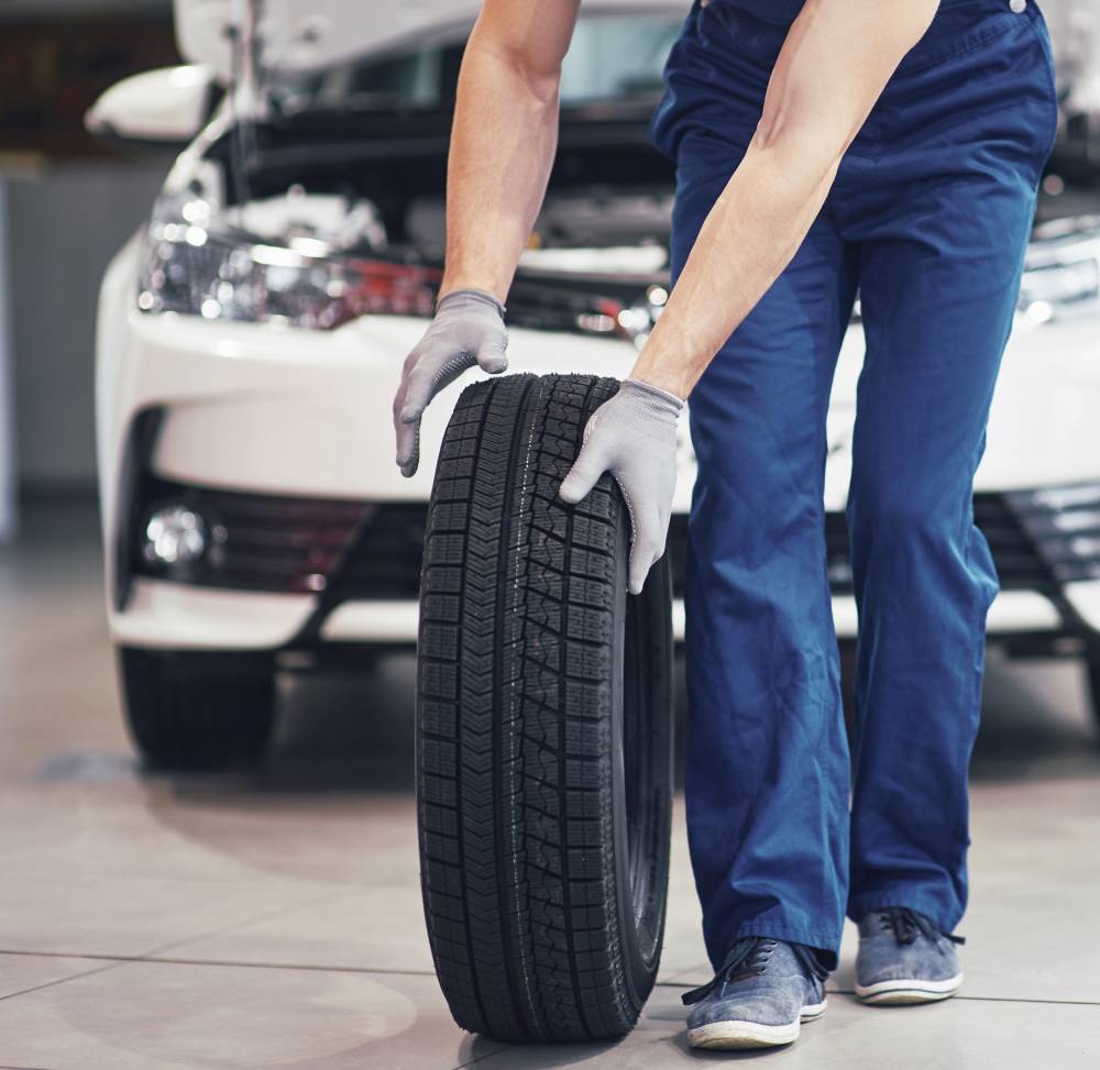 a man holding a tire